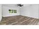 Open living room showcasing wood-look floors and large windows at 5303 Tillman Rd, Lakeland, FL 33810