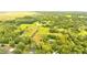 Aerial view of a large property with lush green pastures, trees, and a home at 5303 Tillman Rd, Lakeland, FL 33810