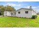 Newly renovated home with white brick exterior, landscaping, and a spacious lawn at 5303 Tillman Rd, Lakeland, FL 33810