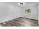 Simple bedroom with wood-look floors and a window offering natural light at 5303 Tillman Rd, Lakeland, FL 33810