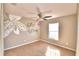 Bedroom with ceiling fan, window, and painted accent wall at 336 Lake Eloise Pointe Dr, Winter Haven, FL 33880