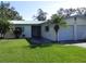Single-story house with a two-car garage and a lawn at 2201 W Pilaklakaha Ave, Auburndale, FL 33823
