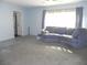 Spacious living room featuring a gray couch and large window at 2201 W Pilaklakaha Ave, Auburndale, FL 33823