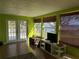 Bright sunroom with access to deck and serene lake views at 2201 W Pilaklakaha Ave, Auburndale, FL 33823