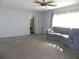 Bright living room with gray couch and ceiling fan at 2201 W Pilaklakaha Ave, Auburndale, FL 33823