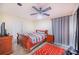 Spacious bedroom with a wooden sleigh bed and ceiling fan at 34415 Kingfish St, Fruitland Park, FL 34731