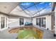 Enclosed pool area with patio furniture and covered structure at 34415 Kingfish St, Fruitland Park, FL 34731
