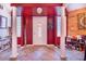 Inviting entryway with red walls, tile floors, and columns at 34415 Kingfish St, Fruitland Park, FL 34731
