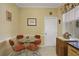 Bright kitchen nook with glass table and four orange chairs at 35 Enclave Dr, Winter Haven, FL 33884
