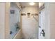 Walk-in shower with pebble tile and grab bar at 35 Enclave Dr, Winter Haven, FL 33884