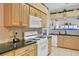Well-equipped kitchen with light wood cabinets and granite countertops at 35 Enclave Dr, Winter Haven, FL 33884