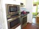 Stainless steel appliances built into white kitchen cabinets at 2201 W Pilaklakaha Ave, Auburndale, FL 33823