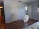 Bedroom with wood flooring, and access to bathroom at 2201 W Pilaklakaha Ave, Auburndale, FL 33823