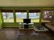 Sunroom with lake views, tiled floor, and ample natural light at 2201 W Pilaklakaha Ave, Auburndale, FL 33823