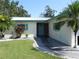 Single-story house with a two-car garage and a lawn at 2201 W Pilaklakaha Ave, Auburndale, FL 33823