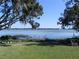 Peaceful backyard with lake view and lush lawn at 2201 W Pilaklakaha Ave, Auburndale, FL 33823