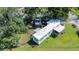 Aerial view of a mobile home with a yard and fence at 1915 Josephine St, Lakeland, FL 33815