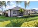 House exterior showcasing well-manicured lawn and screened enclosure at 3820 Traditions N Blvd, Winter Haven, FL 33884