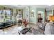 Living room with green walls, wood floors and view to dining area at 3820 Traditions N Blvd, Winter Haven, FL 33884