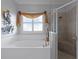 Bathroom with shower, soaking tub, and decorative window treatment at 3820 Traditions N Blvd, Winter Haven, FL 33884