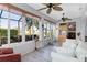Sunroom with hardwood floors, multiple ceiling fans, and view to backyard at 3820 Traditions N Blvd, Winter Haven, FL 33884