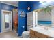 Bathroom with shower/tub combo, beach-themed decor and a door to the outside at 3820 Traditions N Blvd, Winter Haven, FL 33884