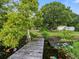 Serene backyard with a wooden dock extending over a calm lake at 126 Bermuda Ct, Winter Haven, FL 33880