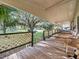 Large front porch with wooden deck and green accents at 126 Bermuda Ct, Winter Haven, FL 33880