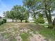 Spacious backyard with mature trees, a shed, and a swing set at 126 Bermuda Ct, Winter Haven, FL 33880