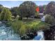 Aerial view of a lakeside home with lush green surroundings at 126 Bermuda Ct, Winter Haven, FL 33880