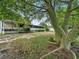 Single-story home with a screened porch, large trees, and a spacious yard at 126 Bermuda Ct, Winter Haven, FL 33880