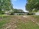 Spacious backyard with mature trees and partial grass at 126 Bermuda Ct, Winter Haven, FL 33880