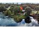 Aerial view showcasing a lakeside house and dock at 126 Bermuda Ct, Winter Haven, FL 33880