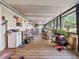 Large screened porch with wooden floors and plenty of seating at 126 Bermuda Ct, Winter Haven, FL 33880