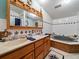 Large bathroom with double vanity, a jetted tub, and a shower at 126 Bermuda Ct, Winter Haven, FL 33880