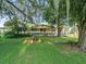 Ranch style home with large front porch and mature trees at 126 Bermuda Ct, Winter Haven, FL 33880