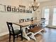 Farmhouse-style dining room with wood table, bench, and chandelier at 210 Lake Thomas Dr, Winter Haven, FL 33880