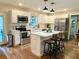 Modern kitchen with white cabinets, island, and stainless steel appliances at 210 Lake Thomas Dr, Winter Haven, FL 33880