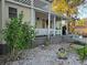 Front yard features a covered porch, white lattice railing, and landscaping at 2418 W 1St St, Sanford, FL 32771