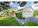 Single story home with two car garage and landscaped yard at 4189 Cannes Ave, Lake Wales, FL 33859