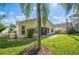 Backyard view of home with patio and palm trees at 4189 Cannes Ave, Lake Wales, FL 33859
