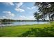 Peaceful lakefront property with a grassy area at 4189 Cannes Ave, Lake Wales, FL 33859