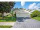 Single story home with two car garage and landscaped yard at 4189 Cannes Ave, Lake Wales, FL 33859