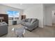 Versatile bonus room with large windows and a comfortable couch at 112 Sofia Ln, Lake Alfred, FL 33850