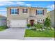 Two-story house with a two-car garage and landscaped yard at 112 Sofia Ln, Lake Alfred, FL 33850