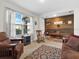 Living room with a rustic feature wall and comfortable seating at 112 Sofia Ln, Lake Alfred, FL 33850