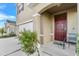 Inviting entryway with a red door and landscaping at 112 Sofia Ln, Lake Alfred, FL 33850