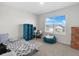 Bright bedroom with a bed, beanbag chair, and shelving unit at 112 Sofia Ln, Lake Alfred, FL 33850