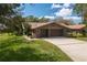 House exterior with a two-car garage and well-maintained lawn at 109 Odin Dr, Winter Haven, FL 33884