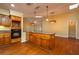 Kitchen with wood cabinets, granite counters, and island at 109 Odin Dr, Winter Haven, FL 33884